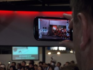 Watching Asimo perform via someone else's smartphone.